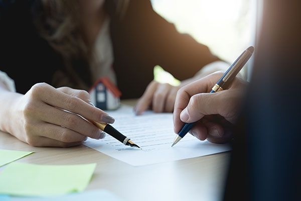 adults signing documents