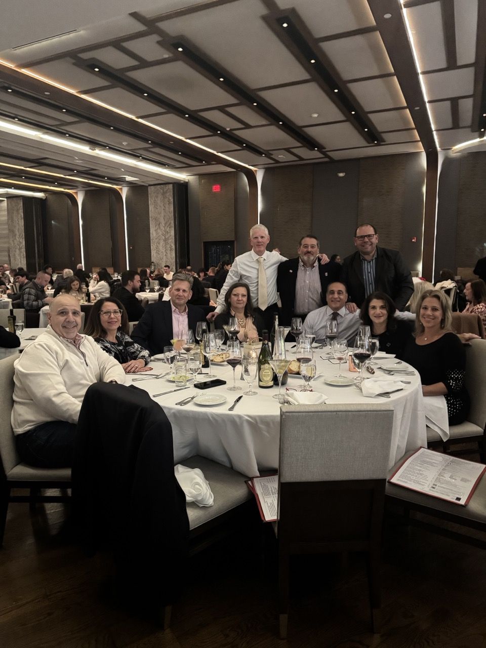Group of Epsilon Sigma brothers and their families (Seated L-R): Ray & Vickie Menna, Jeff & Stephanie Witte, Rich & Nanette Cecchi, Keri Fleming & Mike Shannon (Standing L-R): Matt Bryne, International Counselor Rich Santoriello, Mike Shannon. Not pictured: Brian & Nikki Meyerberg, John & Phylis Mattheson.