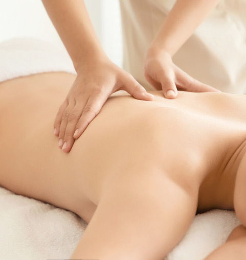 white body on massage table receiving massage to back