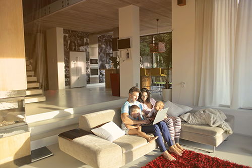 parents and kids sitting on couch in living room