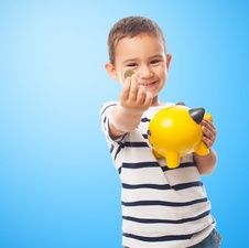 boy with coin infront of blue background