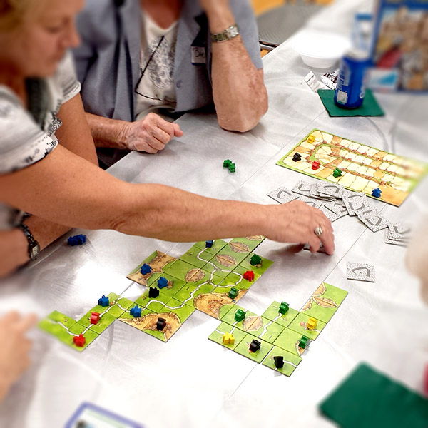 Tabletop Games Images of people playing a board game at the library
