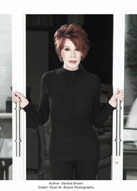 Author Sandra Brown Author Sandra Brown in black top standing between sliding door