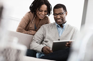 Happy Couple with a Tablet Device Happy Couple with a Tablet Device