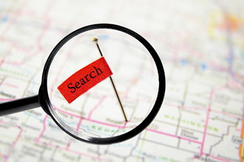 Econmic Dashboard magnifying glass over a map