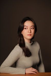 Author Chloe Gong Author Chloe Gong in a grey mock turtleneck against black background