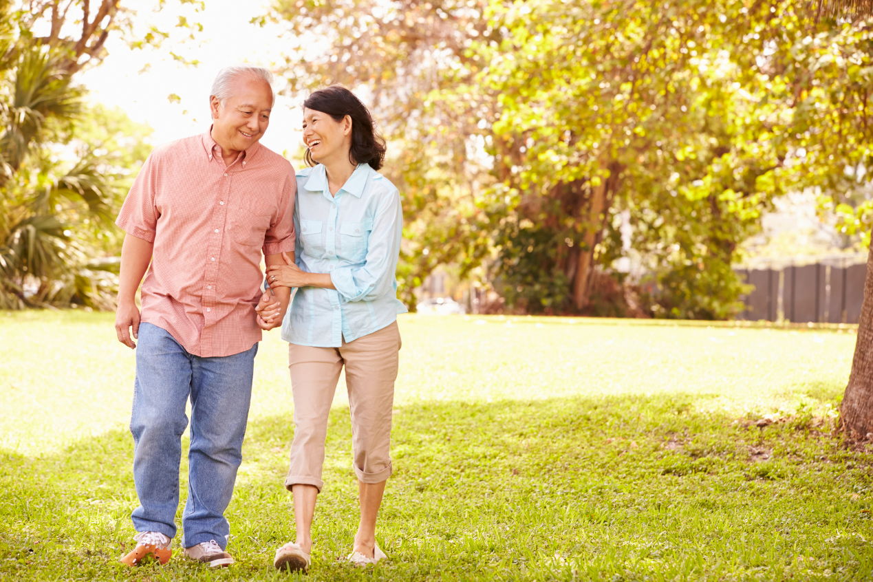 couple in thier 60s walking in the yard