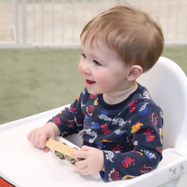 Happy child sitting in a high chair