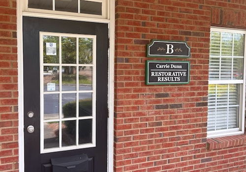 black door with window in a brick building