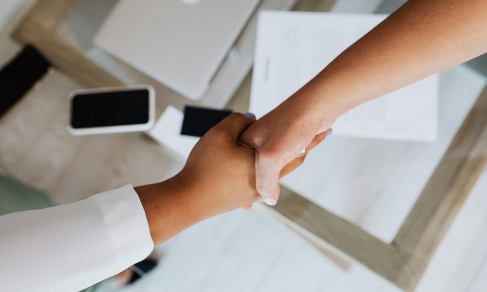 people shaking hands in a business deal