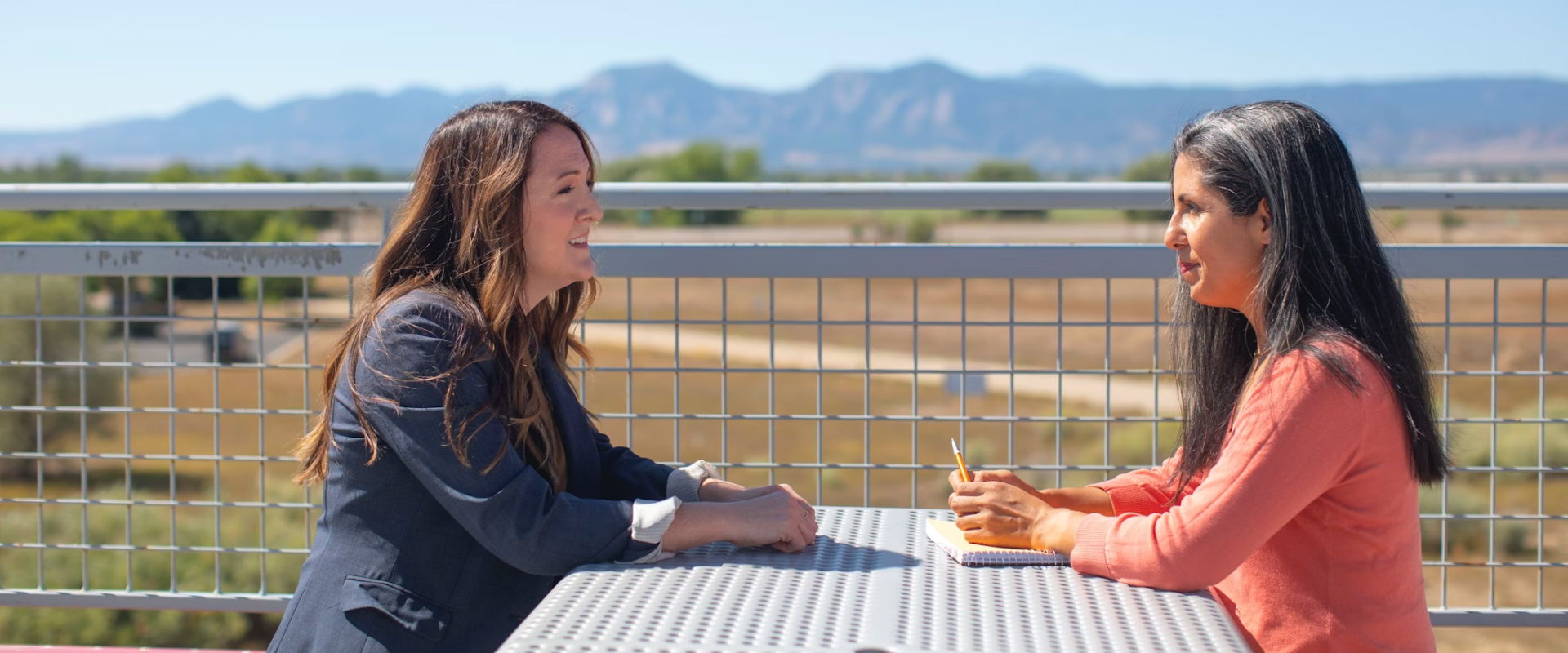 cross-border financial planner sits with client cross-border financial planner sits with client